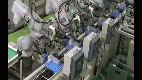 Motoman robots performing electronic component assembly