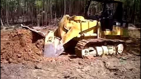 Cat 953C track loader. digging a borrow pit