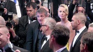 Sean Penn and Charlize Theron at the end of the Mad Max screening at the 2015 Cannes Film Festival