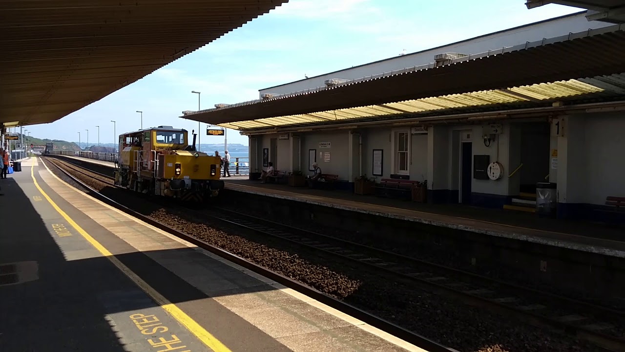 Trains.  A very unusual looking track maintenance machine passing along the Dawlish sea wall