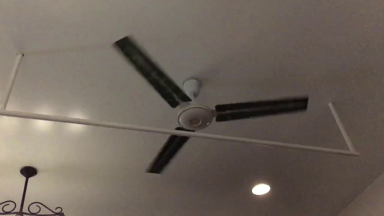 Slo Mo Of A Standard Industrial Commercial Ceiling Fan At A Restaurant