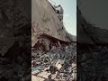 Palestinians write the name of their relatives who are still under the rubble their destroyed home