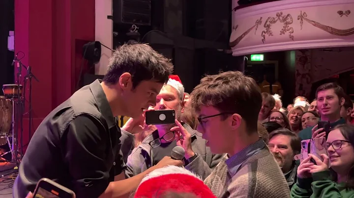 Jamie Cullum singing with guy in the audience In t...