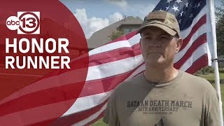 Marathon runner carrying flag to honor others
