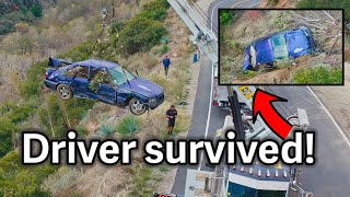 Driver in purple BMW survives crash down mountain