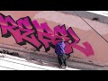 Graffiti bombing . Colored piece on the roof at daytime. Rebel813 and police & security . 4K 2020