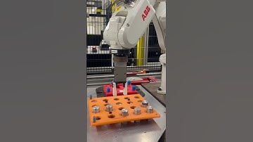 Programming the robot to get the part and load all parts on the conveyor.