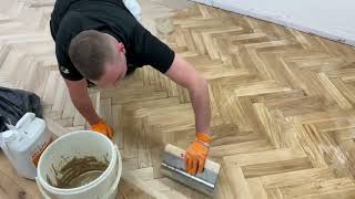 Applying the Bona Mix n Fill to fill the gaps in herringbone floor