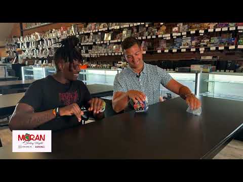 WWE Superstar Je'Von Evans opens cards with Brad Galli at card shop ahead of WWE Raw in Detroit