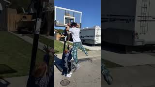 Guy slam dunks over little boy and lands on top of him then he falls to the ground