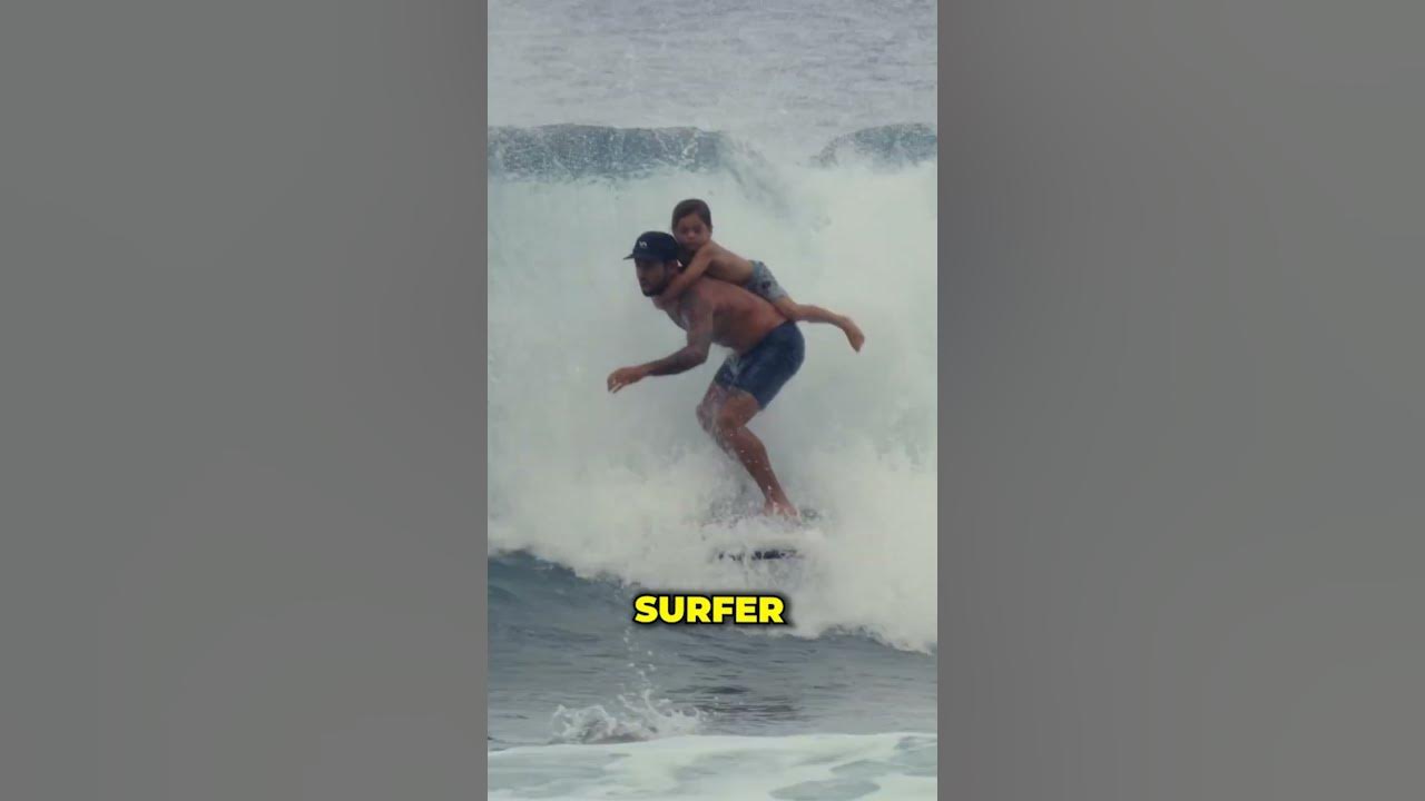 Surfing with his son on his back!❤️😲