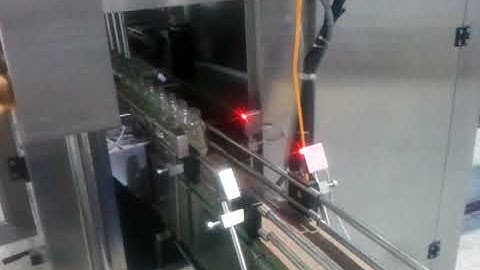 Máy chiết rót vặn nắp dán nhãn hũ dầu dừa