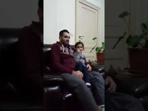 Young Child Correcting Fathers Quran Recitation