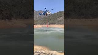 Helicopter firefighting: the process of taking water from the air and extinguishing forest fires