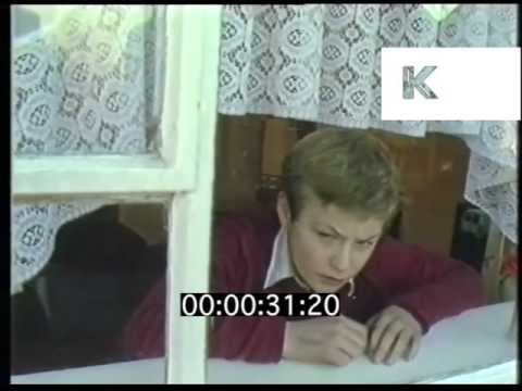 1980s UK Boy At Home Watching TV Looks Out Of Window 