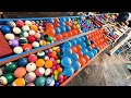 Rolling balls from four clear pipes onto a white circular slope