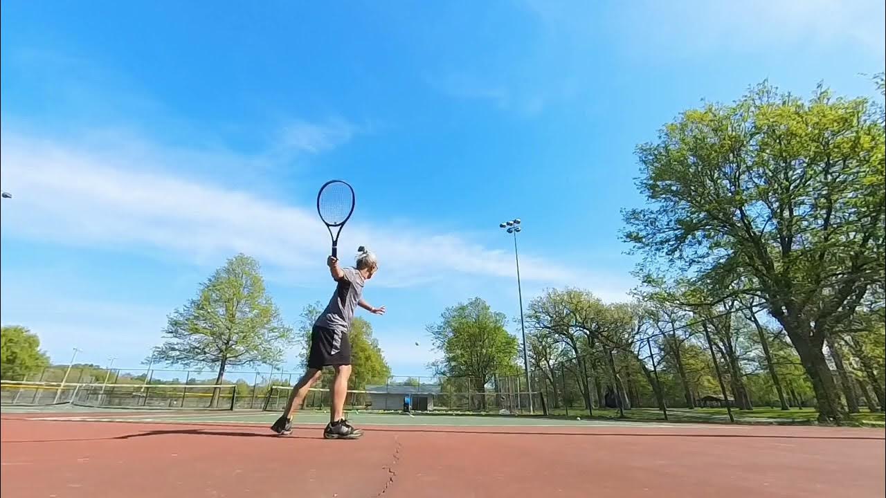 practicing tennis with Slinger tennis balls machine at City Park, Iowa