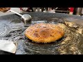 Paratha swimming in dollop of ghee  indian street food