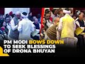 Pm modi touches feet of padma shri awardee drona bhuyan