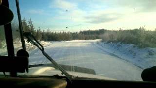 Tri-axle Dump truck pulling Quad Wagon Dump 65,000 kg (143,300lbs) out of oil rig