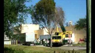 Harrison Crane removing refrigeration unit from Winn Dixie store