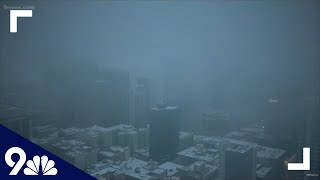 Snow falls in downtown Denver on March 22, 2021