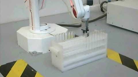 R12 robot arm moving test tubes in a rack