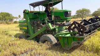 John Deere harvester stuck in mud pulling out by another John Deere harvester | tractor videos |