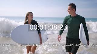 Young surfers couple with surfboards going to study surfing  on ocean beach. Footage highlights.