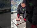 Placing large ceramic floor tiles and using a vibration suction tool to ensure an even surface