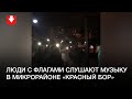 Люди с флагами и фонариками в микрорайоне «Красный Бор»