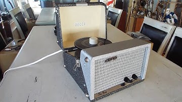 DECCA 45 RPM record player playing a stack of records.