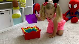 Diana plays with colored toy Pyramid