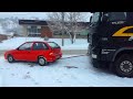 Audi Subaru Pickup and Suv Helping pulls loaded semi Trucks Stuck in Snow