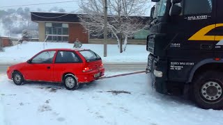 Audi Subaru Pickup and Suv Helping pulls loaded semi Trucks Stuck in Snow