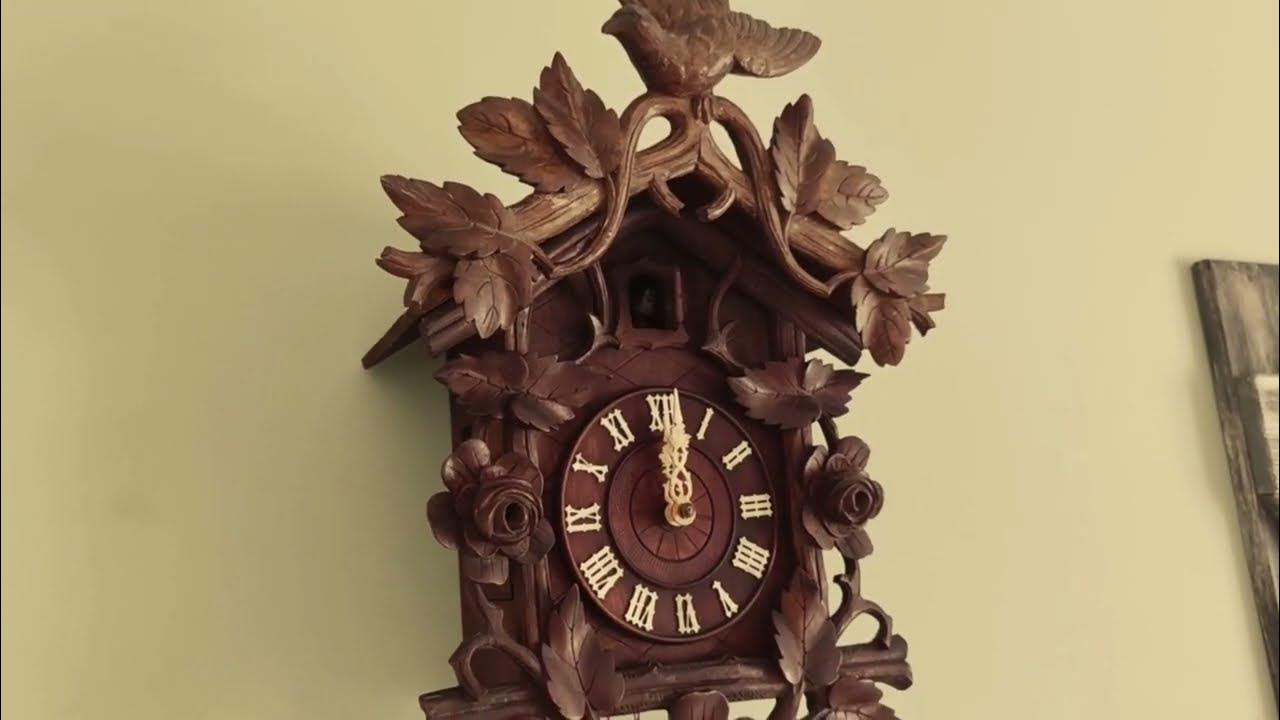 Restored Antique Black Forest Cuckoo clock in action at 12 clock