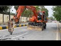 Excavator Going To Pipe Line Work In The Road Centre 