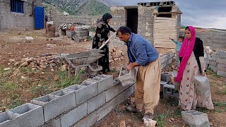Looking for peace: Razia and her family building a yard for their house.