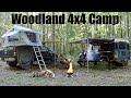 4x4 vehicle based overnight camp in the woods  defender camper  campfire cooking