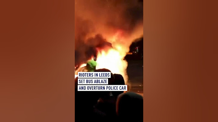 Police car flipped over and bus on fire in Leeds as riots break out