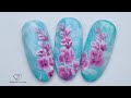 Blooming gel nail art with one stroke flowers using acrylic paints and one stroke nail art brush.