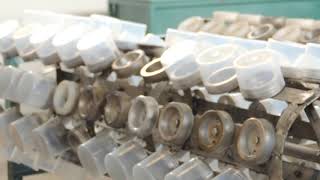 Vacuum Metallizing Process Step 1 - Loading Plastic Caps on Racks