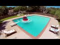 Car rolls off flatbed tow truck into pool