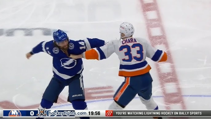 Zdeno Chara checks on Zack McEwan after dropping gloves