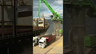 Unloading Cargo Ship With Excavator Crane