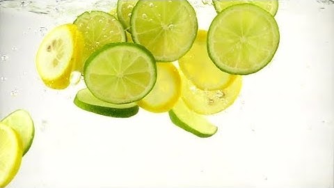 Slices of Lime and Lemon Fall Into a Water with Splashes and Bubbles | Stock Footage - Videohive