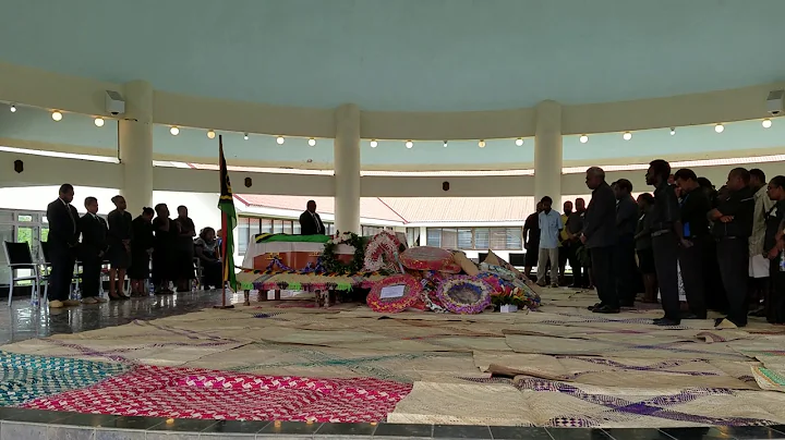 Education department staff sing as Donald Kalpokas lies in state in the Parliamentary rotunda.