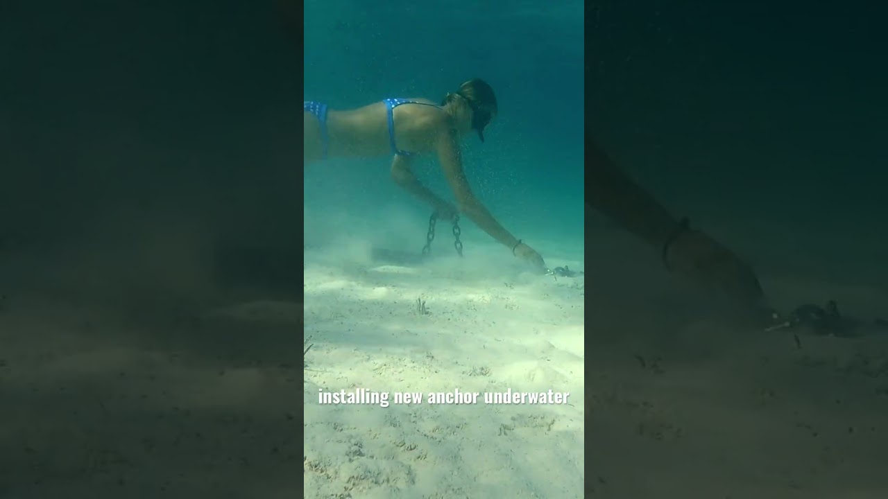 Girl replaces sailboat anchor underwater