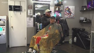 Barber gives haircuts for good grades