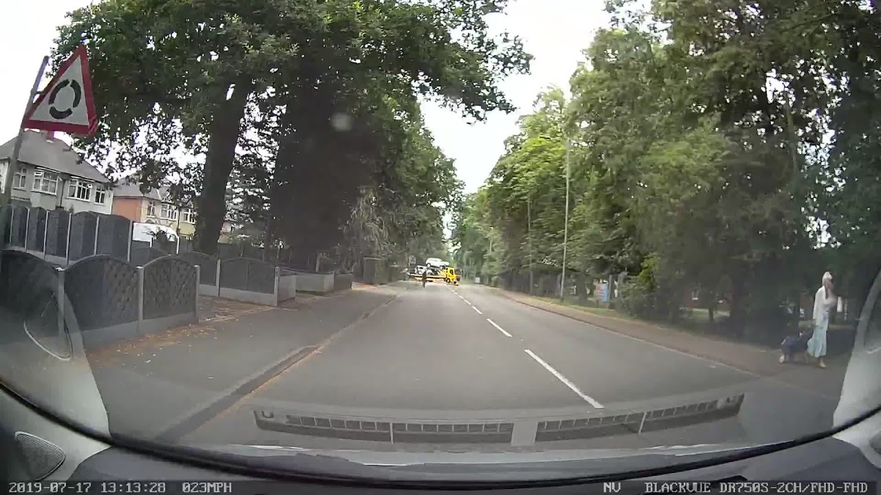 Child on cycle whilst rider using mobile phone.
